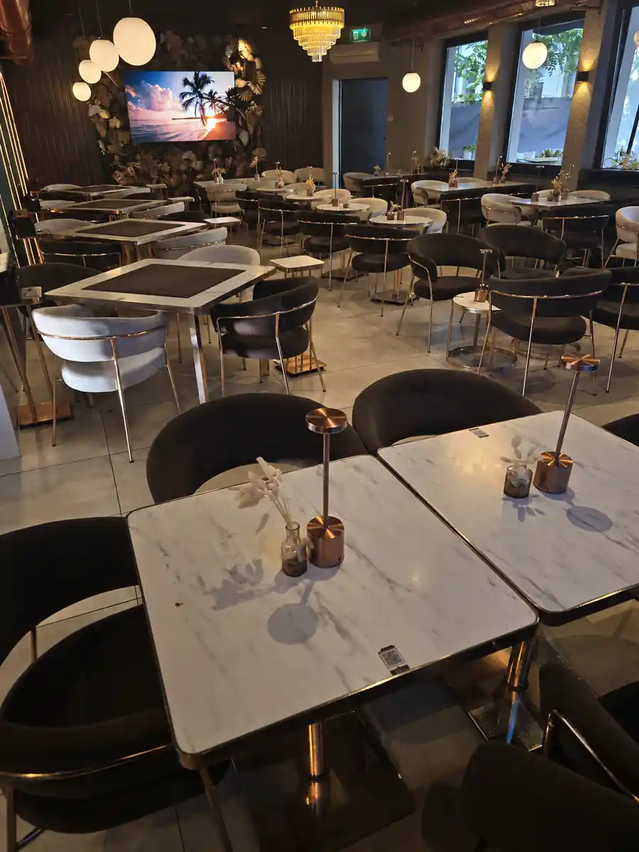 The Leaf interior with marble tables and warm lighting
